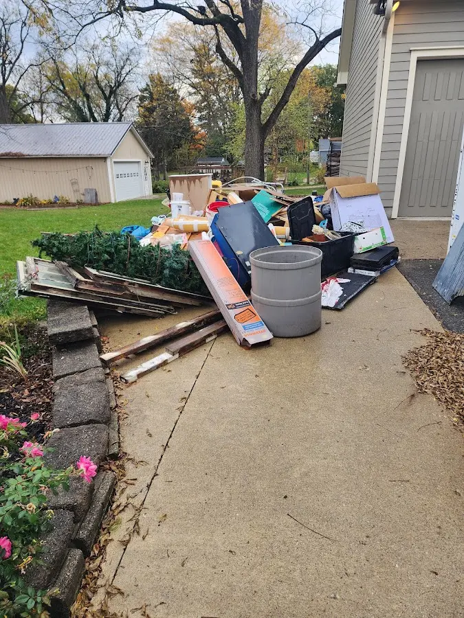 Dumpster being loaded with debris for Estate Cleanout Dumpster Rental in North Smithfield